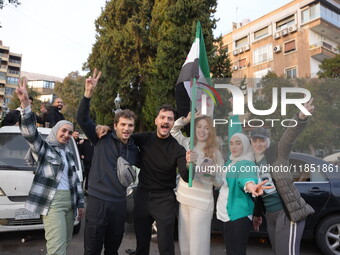 Syrians gather in the Abu Rummaneh neighborhood in central Damascus to celebrate the fall of the Assad regime on December 9, 2024. (