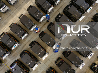 Workers debug smart mobile charging piles at Nantong Guoxuan New Energy Technology Co., LTD., located in Nantong High-tech Zone, East China'...