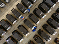 Workers debug smart mobile charging piles at Nantong Guoxuan New Energy Technology Co., LTD., located in Nantong High-tech Zone, East China'...