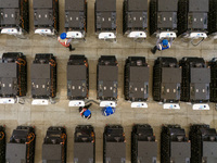 Workers debug smart mobile charging piles at Nantong Guoxuan New Energy Technology Co., LTD., located in Nantong High-tech Zone, East China'...