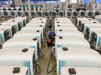 Workers debug smart mobile charging piles at Nantong Guoxuan New Energy Technology Co., LTD., located in Nantong High-tech Zone, East China'...