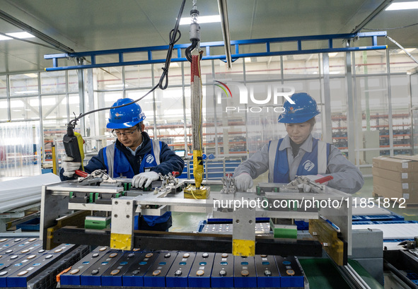 Workers produce energy storage batteries at Nantong Guoxuan New Energy Technology Co., Ltd. in Nantong High-tech Zone, East China's Jiangsu...