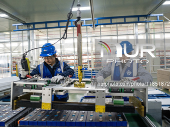 Workers produce energy storage batteries at Nantong Guoxuan New Energy Technology Co., Ltd. in Nantong High-tech Zone, East China's Jiangsu...