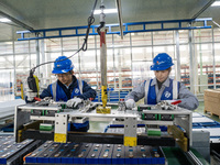 Workers produce energy storage batteries at Nantong Guoxuan New Energy Technology Co., Ltd. in Nantong High-tech Zone, East China's Jiangsu...