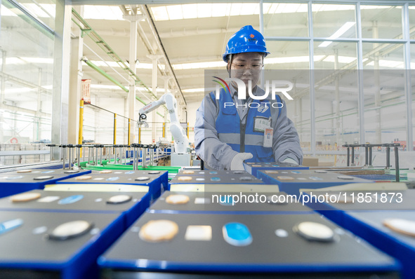 A worker produces energy storage batteries at Nantong Guoxuan New Energy Technology Co., Ltd. in Nantong High-tech Zone, East China's Jiangs...