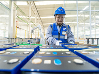 A worker produces energy storage batteries at Nantong Guoxuan New Energy Technology Co., Ltd. in Nantong High-tech Zone, East China's Jiangs...