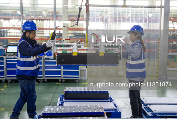 Workers produce energy storage batteries at Nantong Guoxuan New Energy Technology Co., Ltd. in Nantong High-tech Zone, East China's Jiangsu...