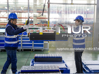 Workers produce energy storage batteries at Nantong Guoxuan New Energy Technology Co., Ltd. in Nantong High-tech Zone, East China's Jiangsu...