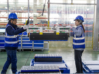 Workers produce energy storage batteries at Nantong Guoxuan New Energy Technology Co., Ltd. in Nantong High-tech Zone, East China's Jiangsu...