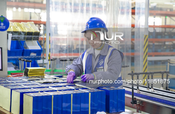 A worker produces energy storage batteries at Nantong Guoxuan New Energy Technology Co., Ltd. in Nantong High-tech Zone, East China's Jiangs...