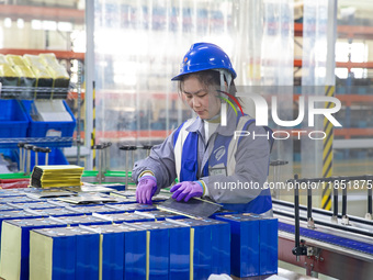 A worker produces energy storage batteries at Nantong Guoxuan New Energy Technology Co., Ltd. in Nantong High-tech Zone, East China's Jiangs...