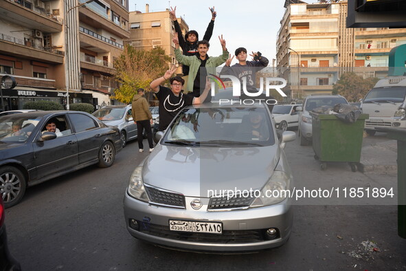 Syrians gather in the Abu Rummaneh neighborhood in central Damascus to celebrate the fall of the Assad regime on December 9, 2024. 