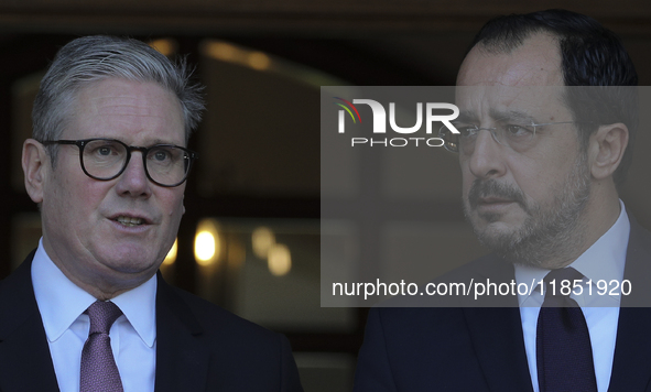 Britain's Prime Minister Keir Starmer talks with Cyprus' President Nikos Christodoulides as he leaves the Presidential Palace in Nicosia. Cy...