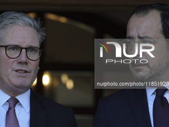 Britain's Prime Minister Keir Starmer talks with Cyprus' President Nikos Christodoulides as he leaves the Presidential Palace in Nicosia. Cy...