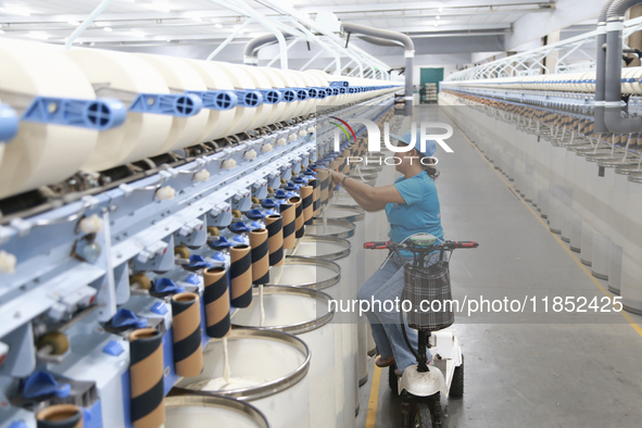 A worker works at a textile workshop of Xinjiang Jingyi Textile Technology Co., Ltd. in Aksu prefecture, Northwest China's Xinjiang Uygur au...