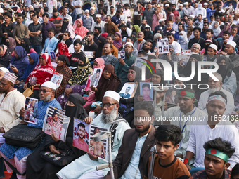 Protesters gather for a rally by Mayer Daak, a platform for the victims of enforced disappearances, on International Human Rights Day in Dha...