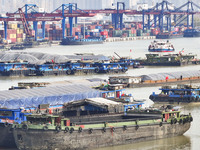 Cargo ships load and unload containers at the Port of Huai'an in Jiangsu province, China, on December 10, 2024. (