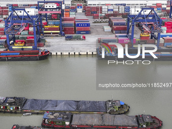 Cargo ships load and unload containers at the Port of Huai'an in Jiangsu province, China, on December 10, 2024. (