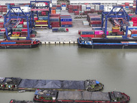 Cargo ships load and unload containers at the Port of Huai'an in Jiangsu province, China, on December 10, 2024. (