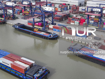 Cargo ships load and unload containers at the Port of Huai'an in Jiangsu province, China, on December 10, 2024. (