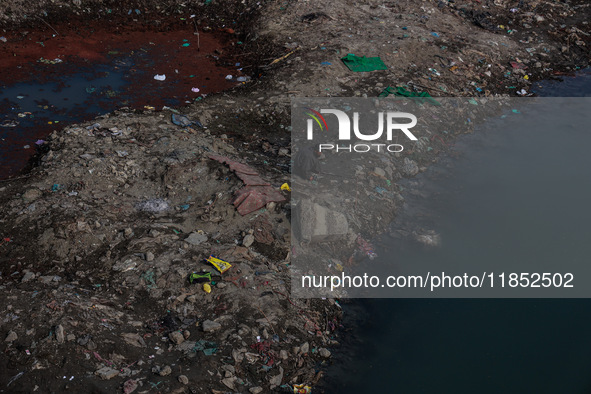 A person catches fish on the banks of the Jhelum River in Sopore, Jammu and Kashmir, India, on December 10, 2024, on a cold winter morning. 