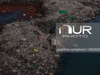 A person catches fish on the banks of the Jhelum River in Sopore, Jammu and Kashmir, India, on December 10, 2024, on a cold winter morning....