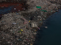 A person catches fish on the banks of the Jhelum River in Sopore, Jammu and Kashmir, India, on December 10, 2024, on a cold winter morning....