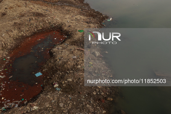 A person catches fish on the banks of the Jhelum River in Sopore, Jammu and Kashmir, India, on December 10, 2024, on a cold winter morning. 