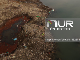 A person catches fish on the banks of the Jhelum River in Sopore, Jammu and Kashmir, India, on December 10, 2024, on a cold winter morning....