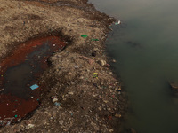 A person catches fish on the banks of the Jhelum River in Sopore, Jammu and Kashmir, India, on December 10, 2024, on a cold winter morning....