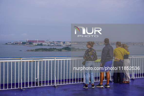 People on board the Stena Line Ferry look at the Sweden Baltic Sea coast in Karlskrona, Sweden, on August 16, 2024. 