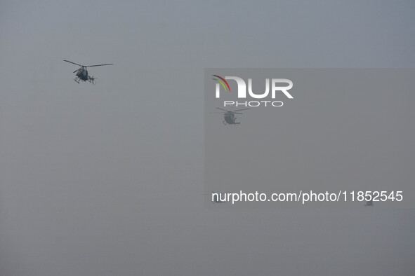 Indian Army helicopters take part in a practice run for the upcoming Vijay Diwas celebrations in Kolkata, India, on December 10, 2024. Vijay...