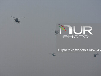 Indian Army helicopters take part in a practice run for the upcoming Vijay Diwas celebrations in Kolkata, India, on December 10, 2024. Vijay...