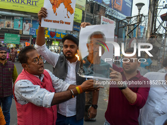 Pro-Hindu activists stage a protest in Kolkata, India, on December 10, 2024, against the attack on minorities in Bangladesh. They burn a pic...