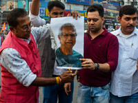 Pro-Hindu activists stage a protest in Kolkata, India, on December 10, 2024, against the attack on minorities in Bangladesh. They burn a pic...