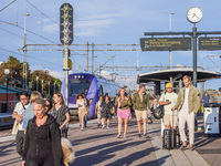 People are on the railway train station deck in Ystad, Sweden, on August 4, 2024. (