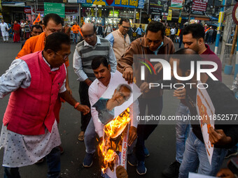 Pro-Hindu activists stage a protest in Kolkata, India, on December 10, 2024, against the attack on minorities in Bangladesh. They burn a pic...