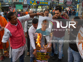 Pro-Hindu activists stage a protest in Kolkata, India, on December 10, 2024, against the attack on minorities in Bangladesh. They burn a pic...