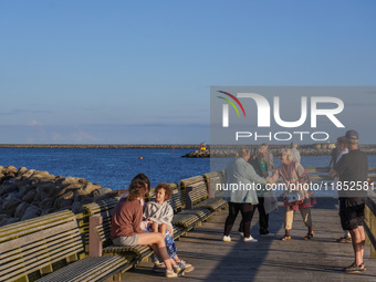 People meet on the promenade in Ystad, Sweden, on August 4, 2024 (