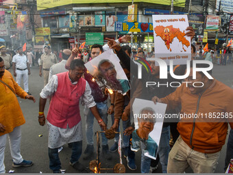 Pro-Hindu activists stage a protest in Kolkata, India, on December 10, 2024, against the attack on minorities in Bangladesh. They burn a pic...