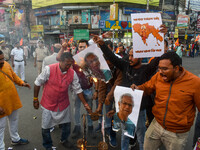 Pro-Hindu activists stage a protest in Kolkata, India, on December 10, 2024, against the attack on minorities in Bangladesh. They burn a pic...