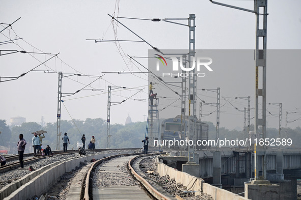 Labourers work on a newly constructed Ganga Rail Bridge built over the river Ganges at the Sangam area in Prayagraj, India, on December 10,...