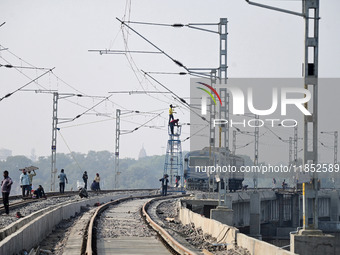 Labourers work on a newly constructed Ganga Rail Bridge built over the river Ganges at the Sangam area in Prayagraj, India, on December 10,...