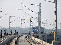 Labourers work on a newly constructed Ganga Rail Bridge built over the river Ganges at the Sangam area in Prayagraj, India, on December 10,...