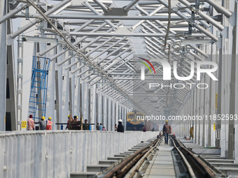 Labourers work on a newly constructed Ganga Rail Bridge built over the river Ganges at the Sangam area in Prayagraj, India, on December 10,...