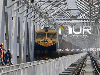 Labourers work on a newly constructed Ganga Rail Bridge built over the river Ganges at the Sangam area in Prayagraj, India, on December 10,...