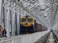 Labourers work on a newly constructed Ganga Rail Bridge built over the river Ganges at the Sangam area in Prayagraj, India, on December 10,...