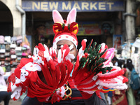 A vendor sells Christmas goodies on a street in Kolkata, India, on December 10, 2024. (