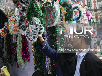 People buy decorative items from a Christmas Market ahead of Christmas in Kolkata, India, on December 10, 2024. (