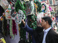 People buy decorative items from a Christmas Market ahead of Christmas in Kolkata, India, on December 10, 2024. (